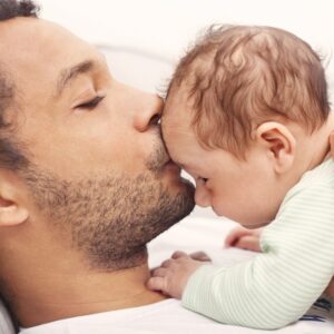 father-holds-infant-kissing-his-forehead